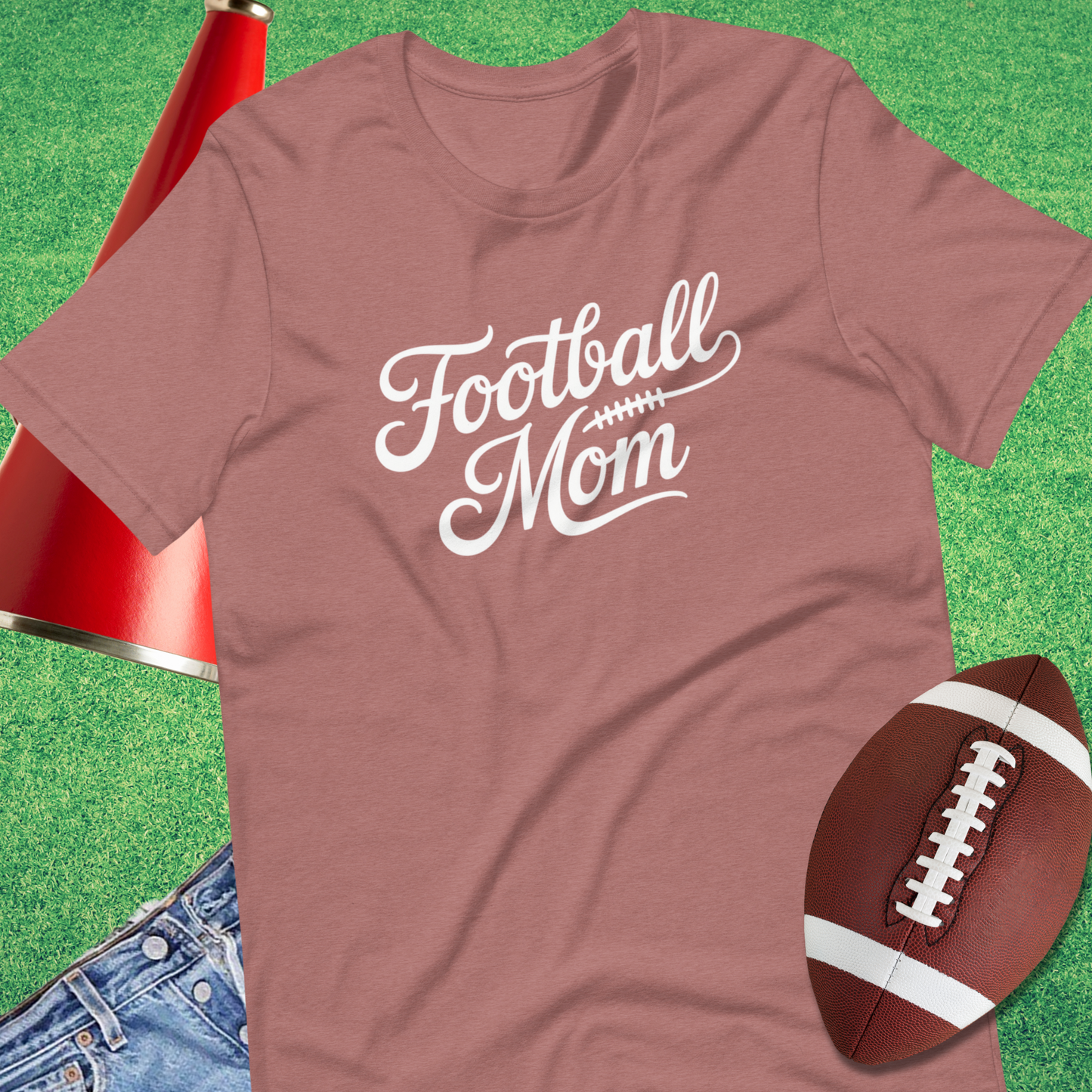 Close-up of classic script football mom design on graphic t-shirt pink