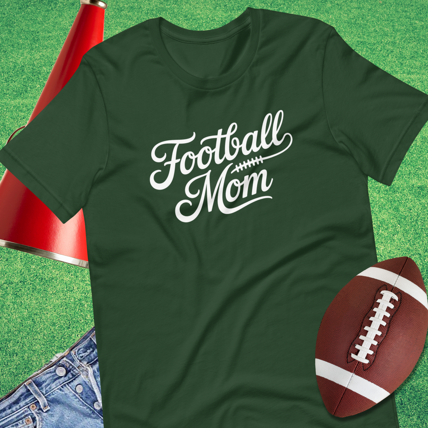Flat lay of Sideline Gods football mom tee with football and team gear gift t-shirt game day