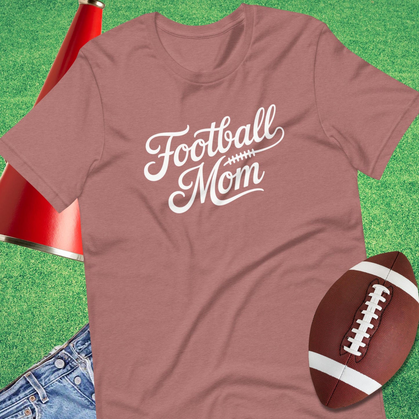 Close-up of classic script football mom design on graphic t-shirt pink